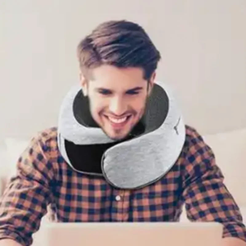Nomad Camel pillow shown in use on airplane seat